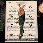 Firefly Notes Maschenmarkierer-Adventskalender 2026 für Strickende mit 12 Türchen, Vorderseite mit Hase im grünen Strickstrumpf vor Noten von „A Sleigh Ride“